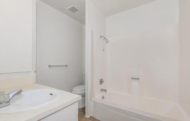 a large white tub sitting next to a sink