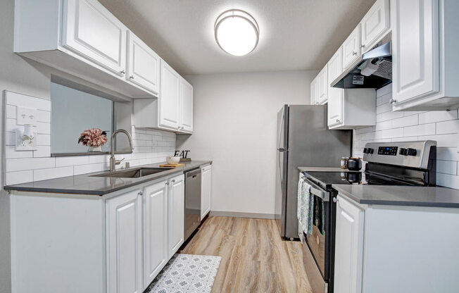 a kitchen with a stove top oven next to a refrigerator