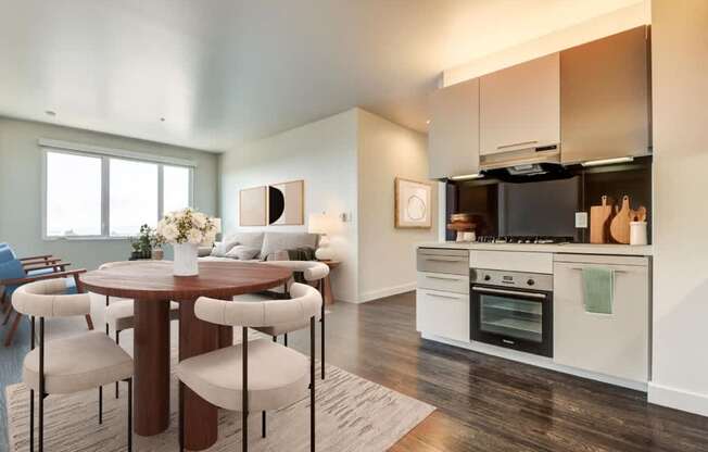 A modern kitchen with a dining table and chairs.