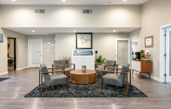 a living room with a table and chairs