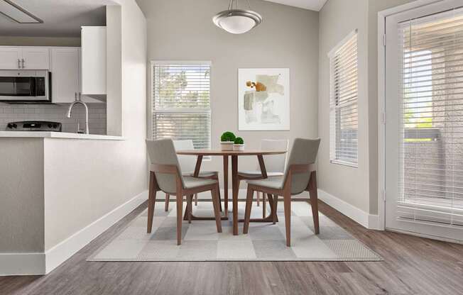 A dining room with a table and chairs.