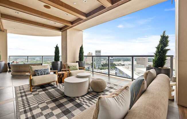 A living room with a large couch and a checkered rug.