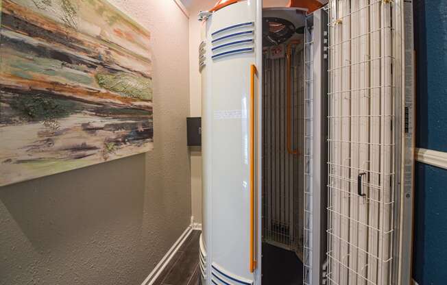 a large heater in a hallway with a painting on the wall