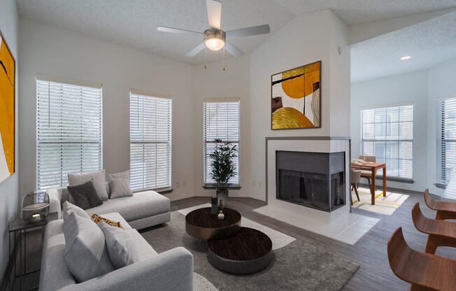 a living room with a couch and a table and a fireplace