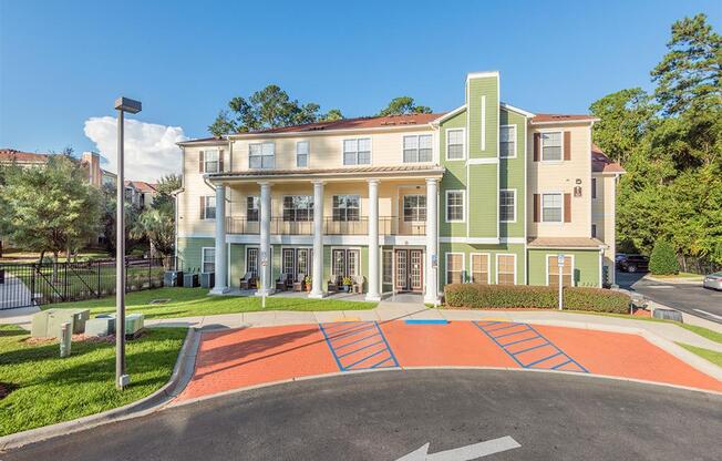 Entrance to leasing center, resident clubhouse, and parking lot at Evergreens at Mahan  in Tallahassee, FL