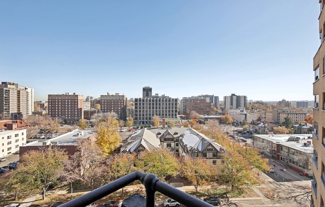 the view of the city from the balcony of an apartment building