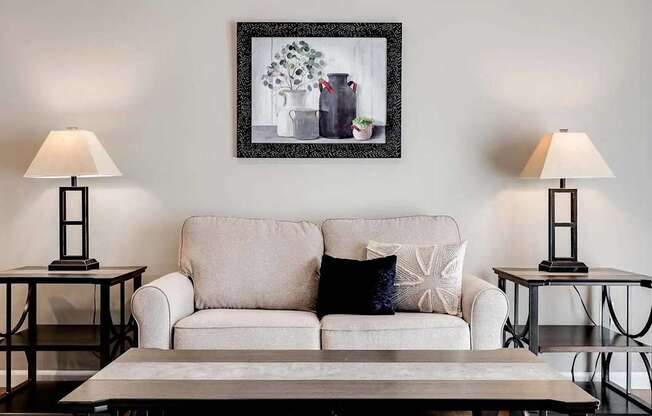 a living room with a couch and a table with lamps. Circle Pines, MN Lexington Lofts