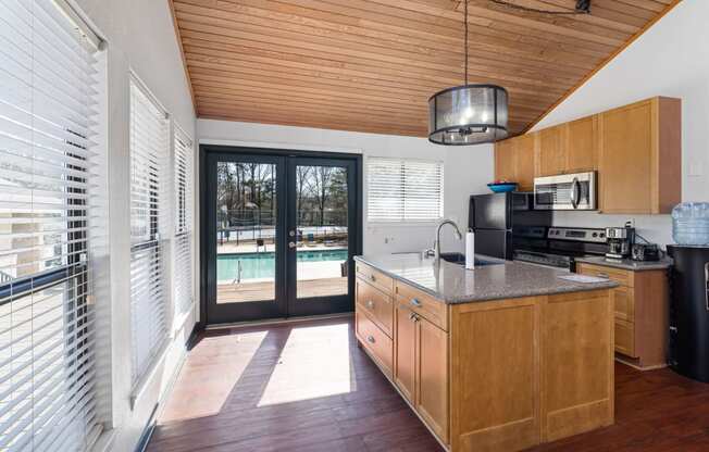 a kitchen with a large island and a door to a swimming pool