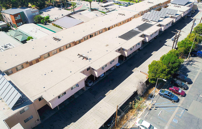 Aerial drone photo of Woodbridge Park Apartments, showing white solar roofs and Solar Panels.
