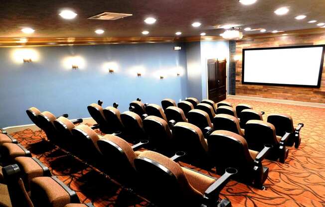 a conference room filled with chairs and a projector screen