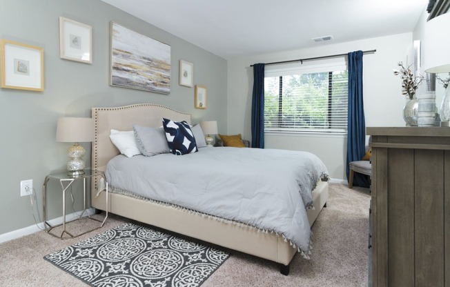 Master bedroom with a neutral color scheme and plenty of natural light at Woods of Fairfax