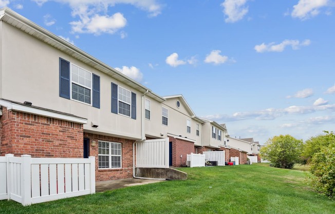 A row of houses with white picket fences.