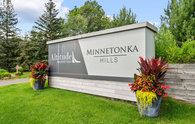 a sign hills at the entrance of a park with flowers