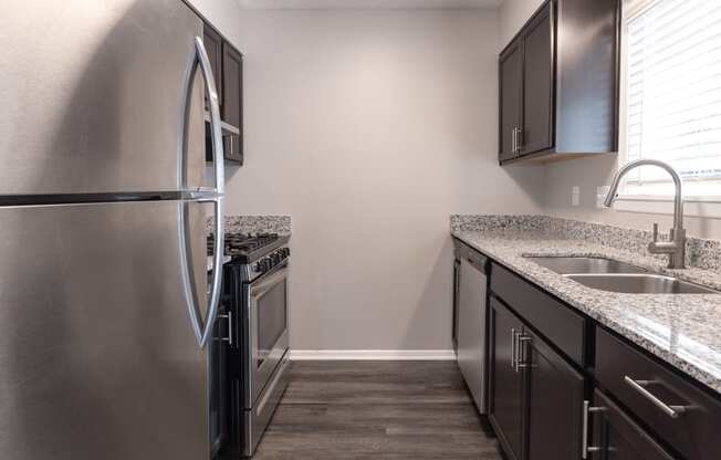 Kitchen with Stainless Steel Appliances in the Two Bedroom Townhome at Woodbridge Apartments Bloomington