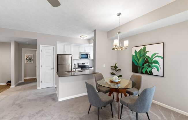 a dining room and kitchen with a table and chairs