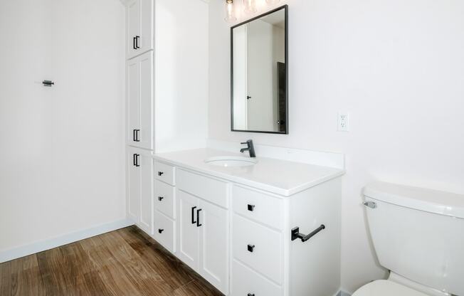 a bathroom with a white sink and toilet and a mirror at The Crossings at Windsong, Arizona, 86314