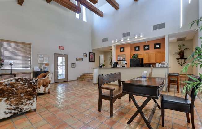 a large living room with a dining table and a kitchen in the background