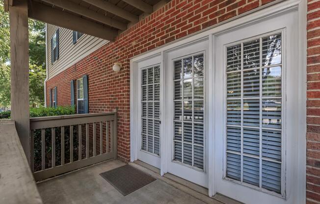Fenced in patio and white patio doors at Ashley Oaks Apartments in Greensboro, North Carolina