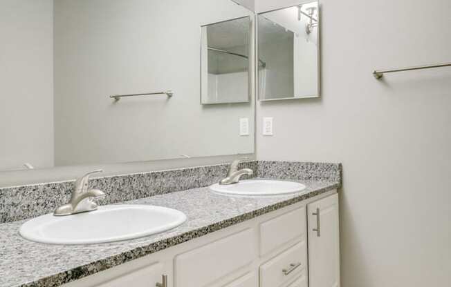 bathroom with dual sinks and white cabinetry at Cascade Pines Duplex and townhomes