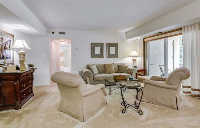 a living room with a couch and chairs and a table