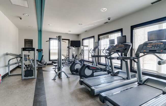 a gym with treadmills and other exercise equipment