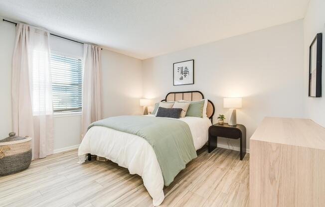 Bed and furniture inside platinum bedroom interior at The Arbor in Blue Springs, Missouri