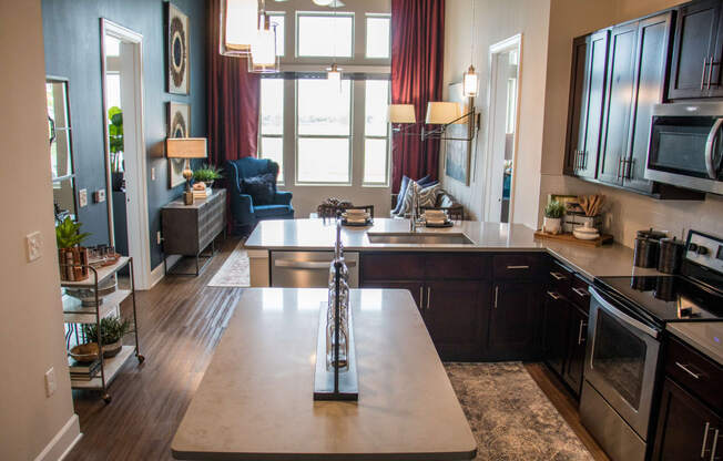 a kitchen and living room with a large window and a table