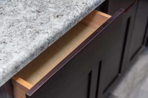 a close up of a kitchen counter with a granite counter top