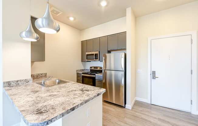 kitchen with hardwood floors, stainless steel appliances and large breakfast bar at city view apartments in washington dc