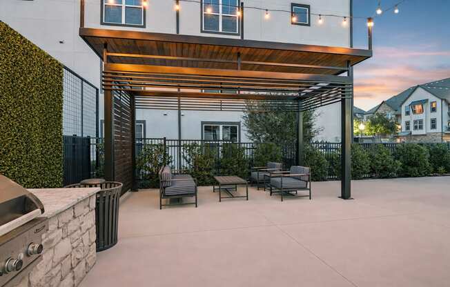 A patio area with a barbecue grill and seating area.