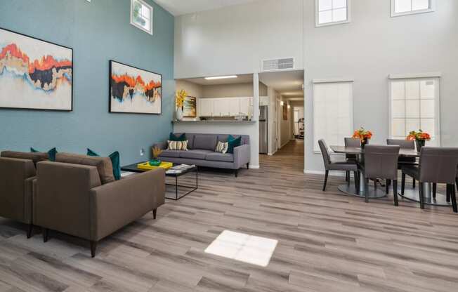 a living room and dining room area with couches and a table and chairs and