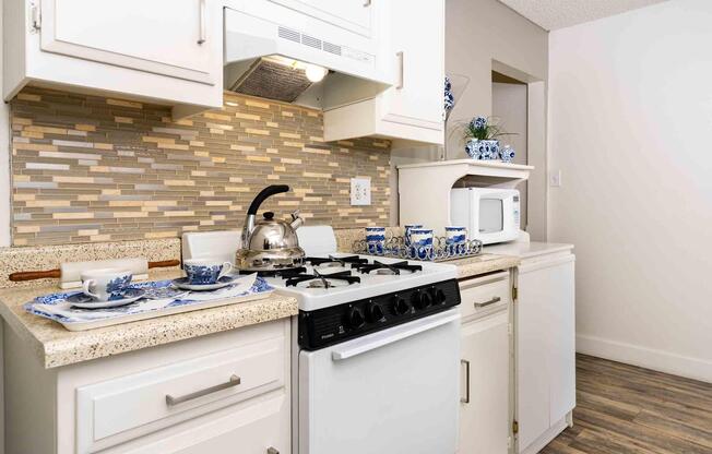 a stove top oven sitting inside of a kitchen