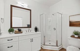 A white bathroom with a mirror, sink, and shower.