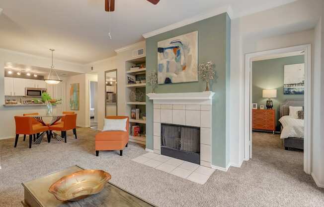 a living room with a fireplace and a table and chairs