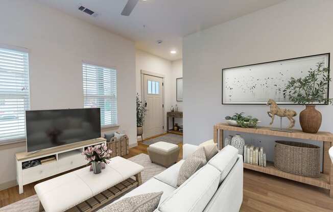 a living room with a white couch and a television