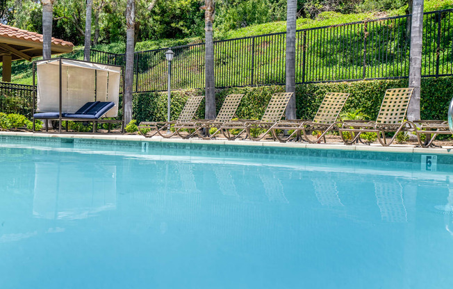 Pool and chaise lounges at 55+ FountainGlen Laguna Niguel