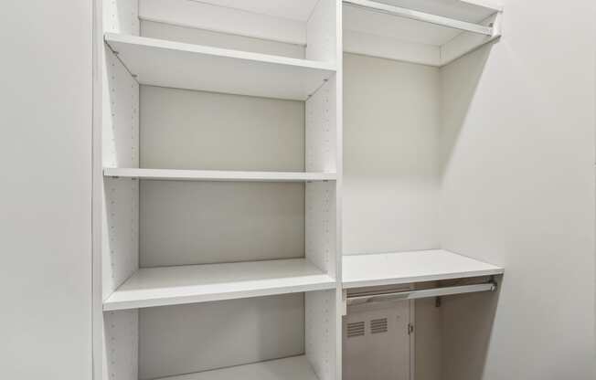 Empty white shelves in a room.