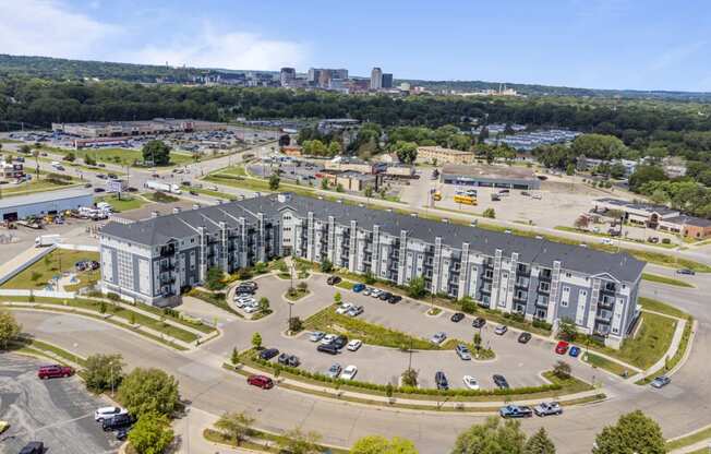 an aerial view of an apartment building in a parking lot