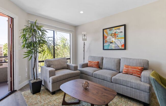 a living room with a couch chair and coffee table