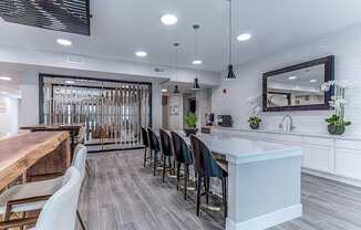 A modern kitchen with a long white island and bar stools.at Tiffany Flats, Columbus, OH, 43231