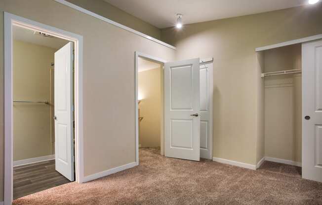 A bedroom with two doors at Arcadia Townhomes, Federal Way, WA