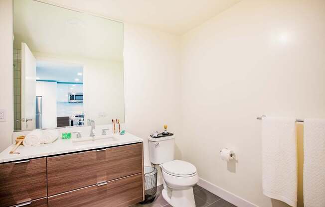A white toilet sits next to a sink in a bathroom.