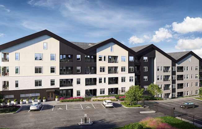 A modern apartment complex with a parking lot in front.