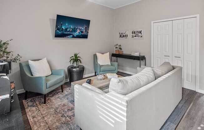 a living room with a couch and two chairs