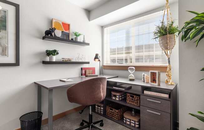 a home office with a desk and a window