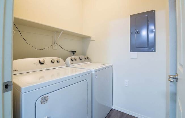 A small laundry room with a washer and dryer.