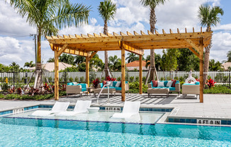 exterior pool with patio furnture and pergola in daytime