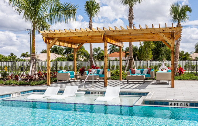 exterior pool with patio furnture and pergola in daytime