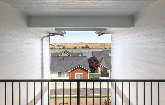 the view from the upstairs balcony of a house overlooking other houses