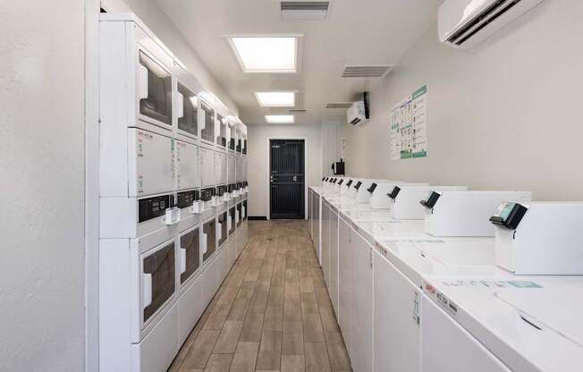a white room with a row of microwaves on the counters